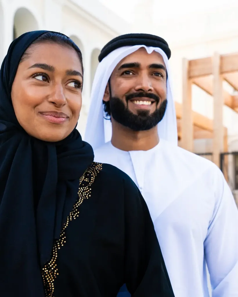 Traditional arab couple wearing emirati clothing dating outdoors
